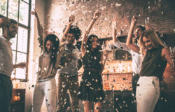 64179434 - enjoying cool party. group of happy young people throwing confetti and jumping while enjoying home party on the kitchen